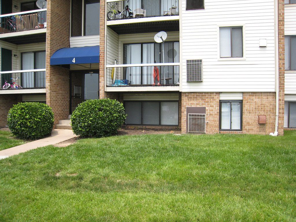 Condominium building with balconies and landscaping
